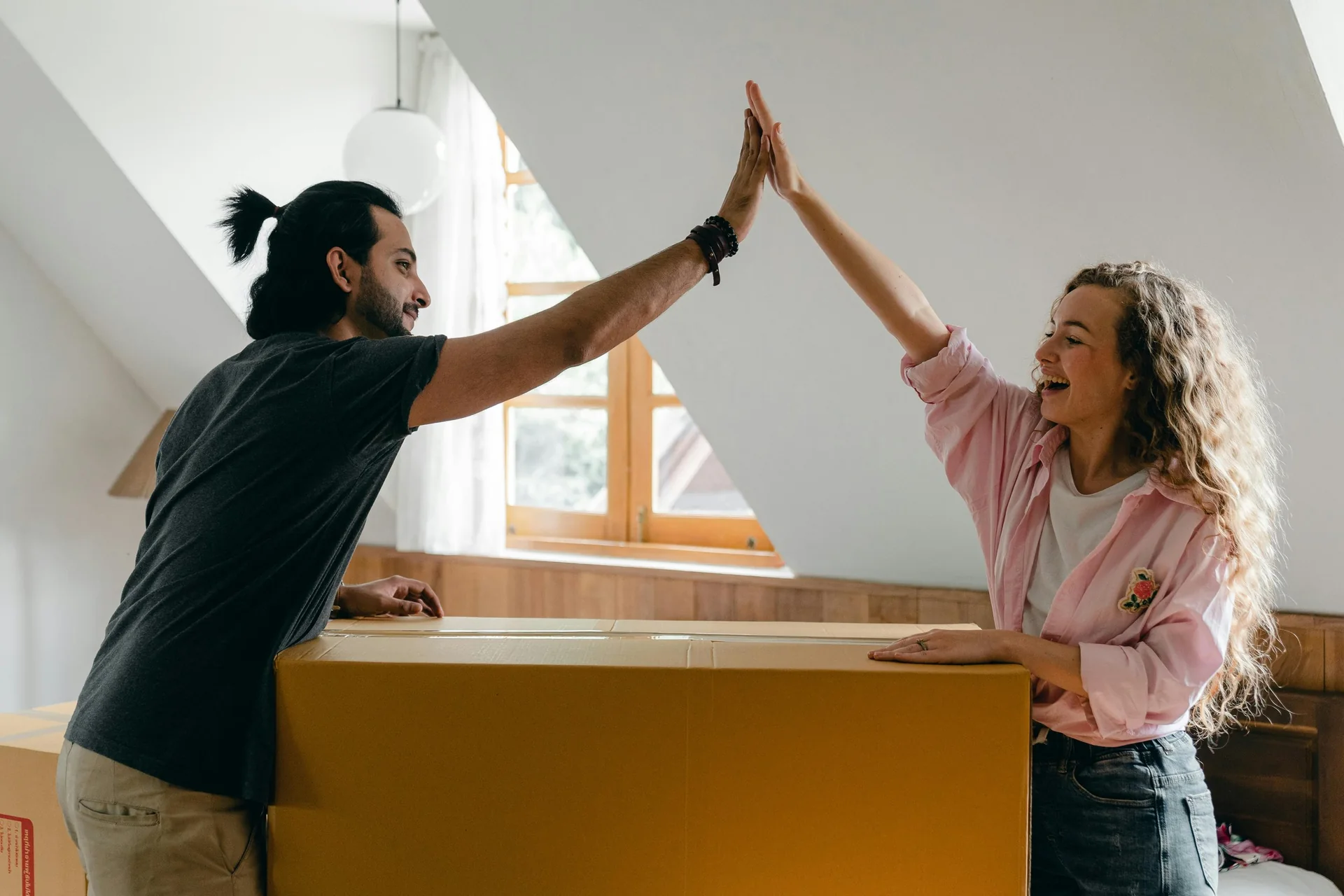 Couple celebrating their move with a high five